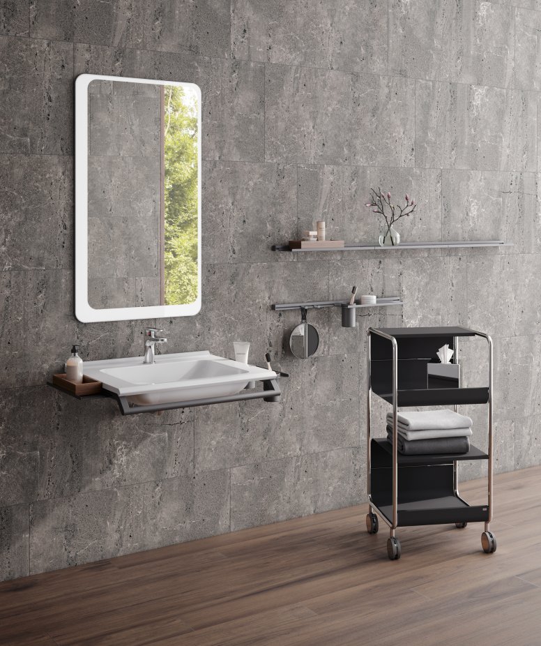 Modular washbasin with grab rail and shelves, side trolley next to it in the colour black matt